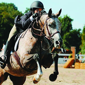 Student riding horse