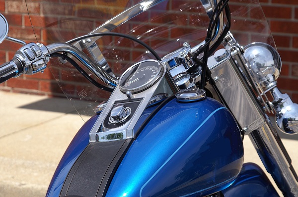 Closeup of a blue motorcycle glimmering in the Florida sunshine.