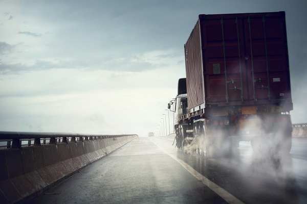 Truck moving fast on wet road